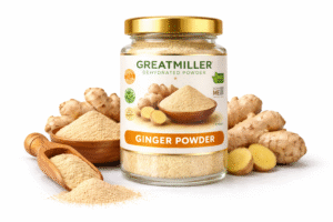 GreatMiller Ginger Powder in glass jar with fresh ginger roots and ground ginger powder on white background