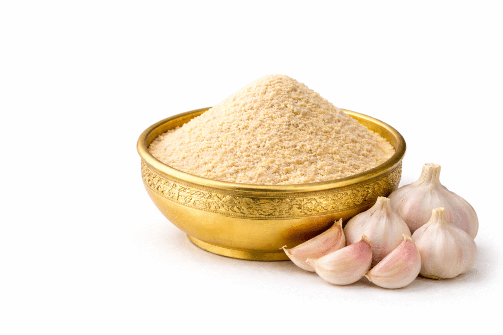 GreatMiller Garlic Powder in golden bowl with fresh garlic cloves