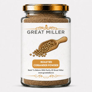 GreatMiller Roasted Coriander Powder in a glass jar with freshly roasted coriander seeds and ground spice on a wooden surface.